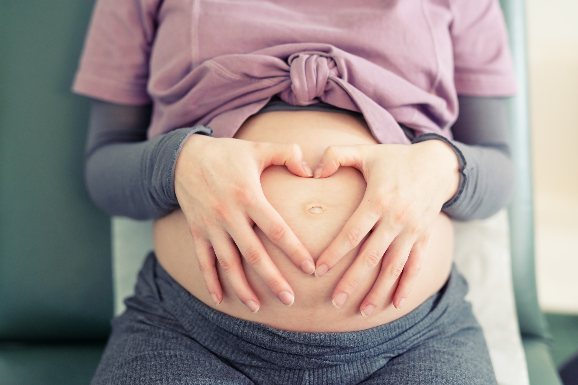 Frontal view of a pregnant woman awaiting the birth of her baby.