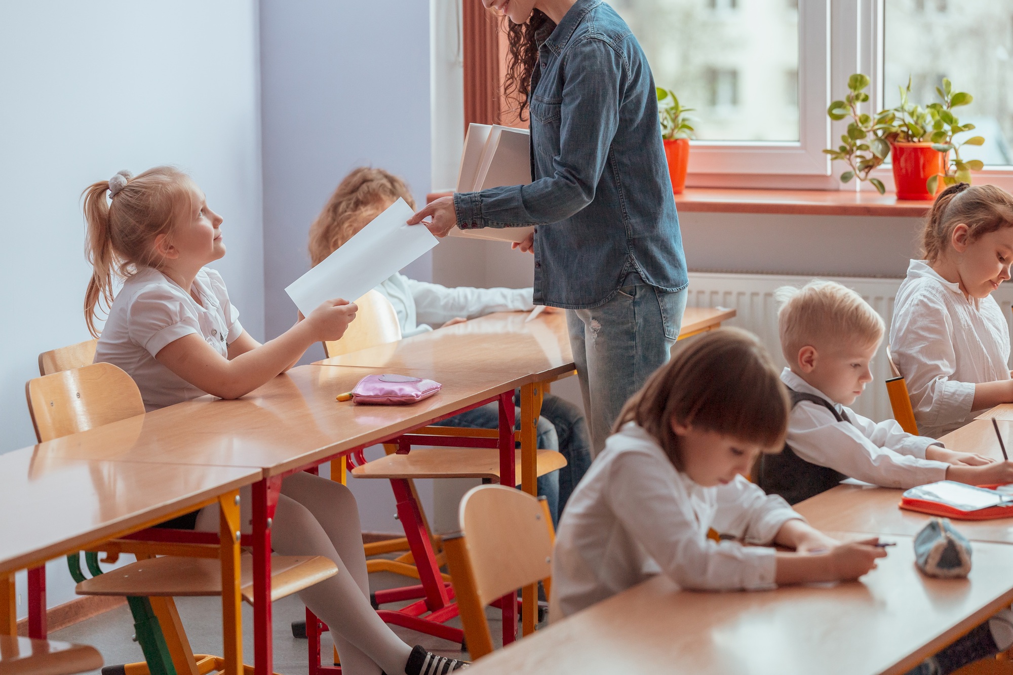 Teacher gives the student a tested and graded test