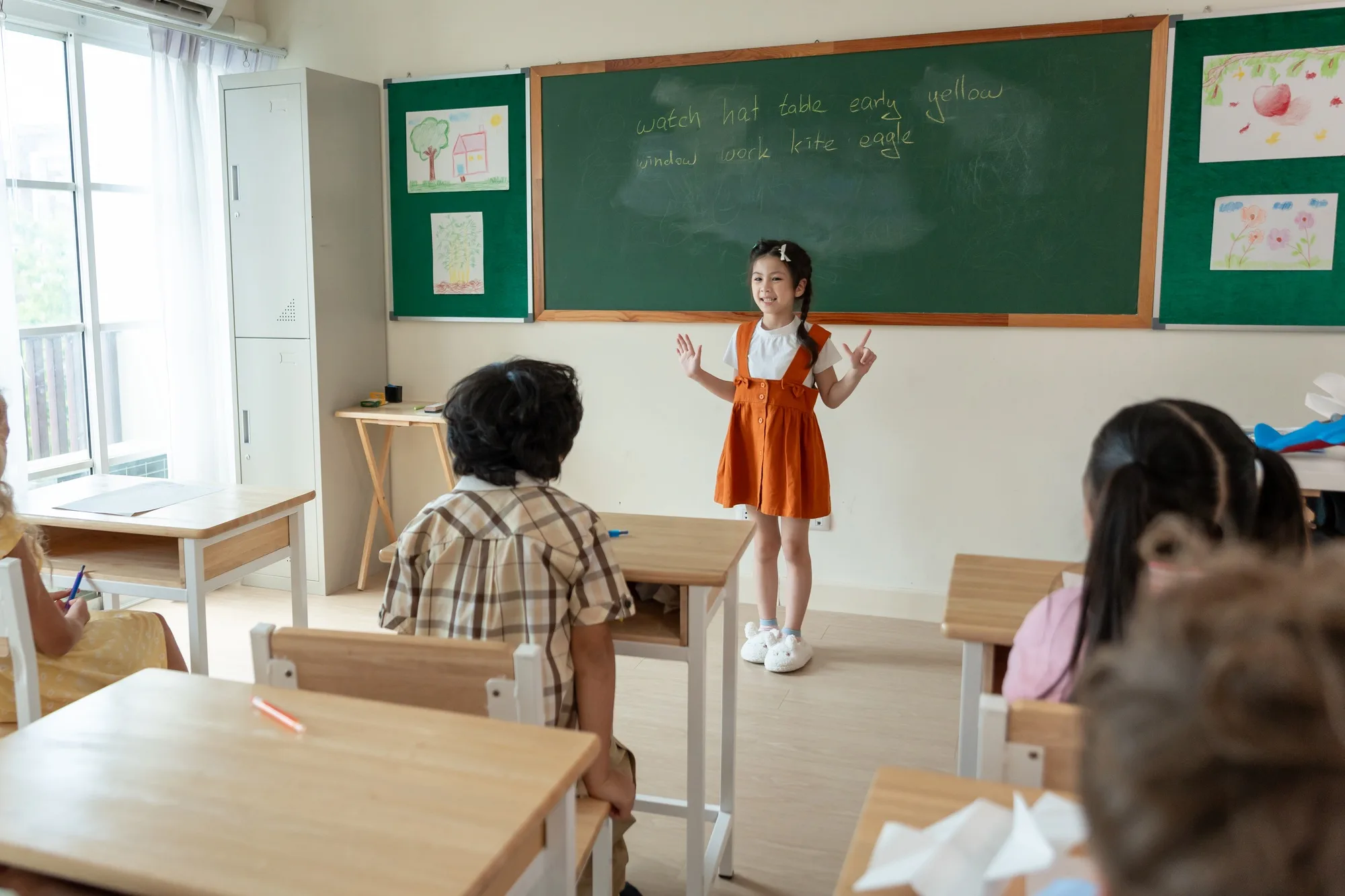 Asian young schoolgirl student dancing in front of classroom at school.