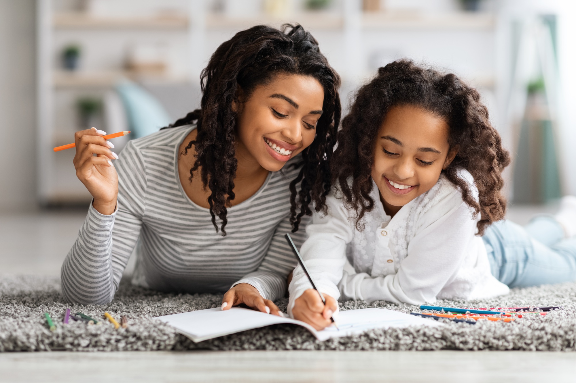 Creative african american family coloring together at home
