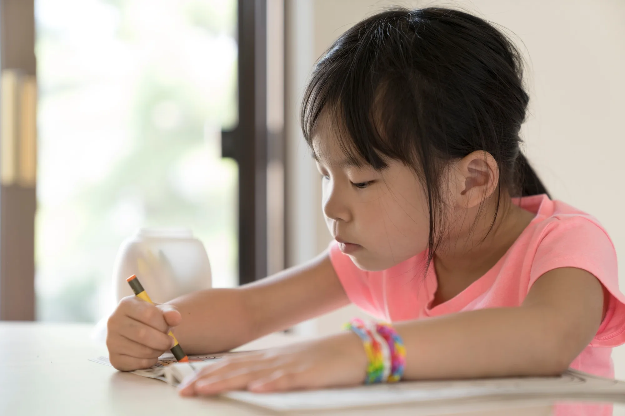 Little girl drawing and coloring
